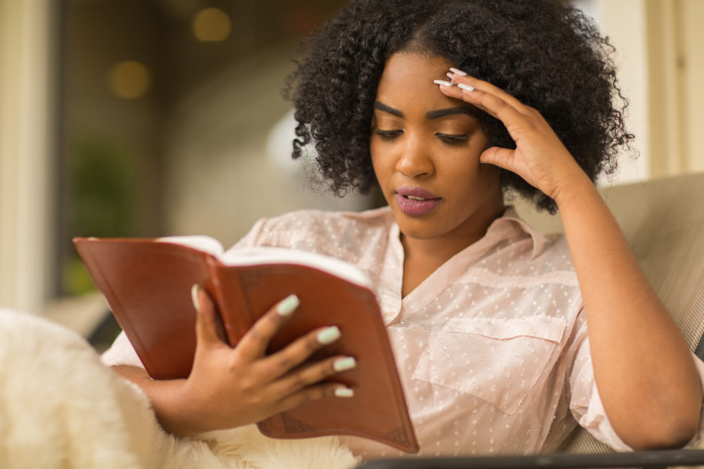 Young woman reading and studying the Bible.