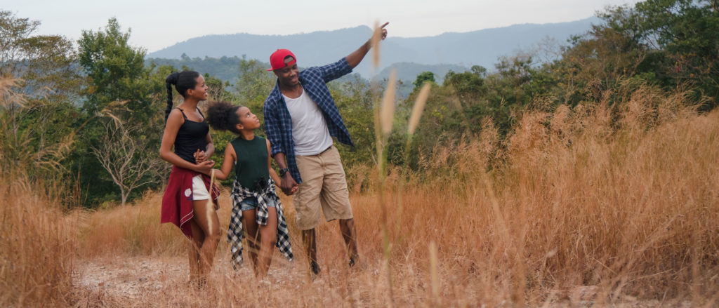 family having fun traveling and camping together in natural forest and park