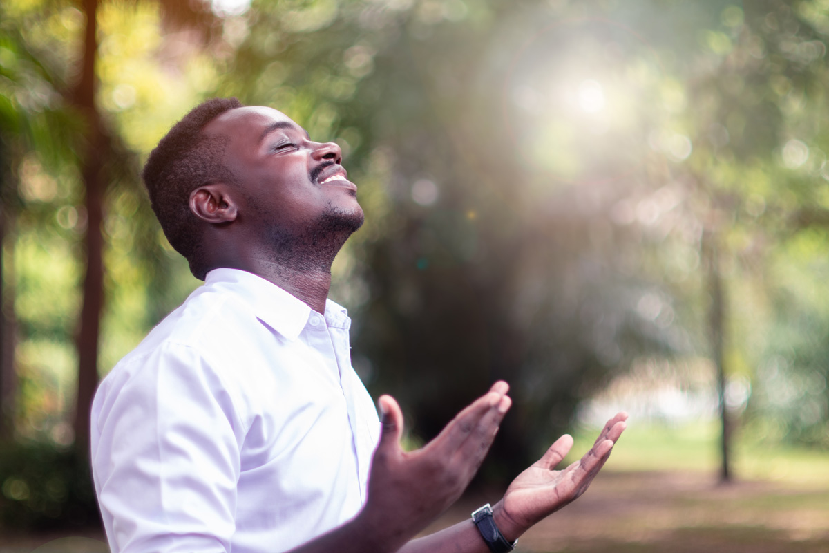 A man opening his hands to God in Johnson City.